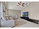 Comfortable living room featuring a large sectional sofa, ceiling fan, and flat screen television at 211 Tavestock Loop, Winter Springs, FL 32708