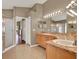 The main bathroom has a dual vanity with walk in shower at 211 Tavestock Loop, Winter Springs, FL 32708