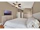 Main bedroom with ceiling fan, hardwood floors, and dual dressers at 211 Tavestock Loop, Winter Springs, FL 32708