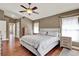 Bright primary bedroom featuring a ceiling fan, hardwood floors, and a neutral color palette at 211 Tavestock Loop, Winter Springs, FL 32708