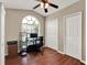 Home office featuring a large arched window, vaulted ceiling, and wood floors at 211 Tavestock Loop, Winter Springs, FL 32708
