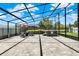 Enclosed patio with a hot tub, outdoor seating, and lush landscaping at 211 Tavestock Loop, Winter Springs, FL 32708