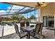 Spacious screened-in patio with an outdoor dining area and view of the backyard at 211 Tavestock Loop, Winter Springs, FL 32708