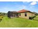 Home exterior features a screened-in lanai and lawn at 212 Lugano Way, Debary, FL 32713