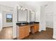 Bright bathroom featuring double sinks, granite countertops, and modern fixtures at 212 Lugano Way, Debary, FL 32713