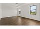 Spacious bedroom with wood-look tile flooring, and natural light from windows at 212 Lugano Way, Debary, FL 32713
