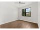 Bright bedroom features wood-look flooring, a ceiling fan, and a large window at 212 Lugano Way, Debary, FL 32713