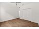 Bedroom with wood-look tile flooring, ceiling fan, and double door closet at 212 Lugano Way, Debary, FL 32713