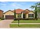 Charming single-story home featuring a well-manicured lawn and eye-catching red tile roof at 212 Lugano Way, Debary, FL 32713