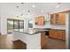A spacious kitchen with a center island, wooden cabinets, and modern stainless steel appliances at 212 Lugano Way, Debary, FL 32713