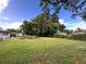 Expansive backyard with lush green grass, surrounded by mature trees, offering plenty of space at 223 Hope Cir, Orlando, FL 32811