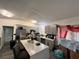 Modern kitchen features gray cabinets, stainless steel appliances, and an island with seating at 223 Hope Cir, Orlando, FL 32811