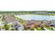 Aerial view of neighborhood homes near a lake with lush landscaping at 2254 Canyon Breeze Ave, Kissimmee, FL 34746