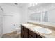 Bathroom with double sinks, granite counters, a toilet, and a shower/tub with a floral curtain at 2254 Canyon Breeze Ave, Kissimmee, FL 34746