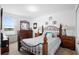 Bedroom featuring a decorative iron bed frame, dresser, matching nightstands, and neutral carpet at 2254 Canyon Breeze Ave, Kissimmee, FL 34746