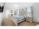Bright bedroom featuring a tufted headboard, matching nightstands and plush carpeting at 2254 Canyon Breeze Ave, Kissimmee, FL 34746