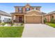 Charming two-story home features a well-manicured lawn, covered entry, and a spacious two-car garage at 2254 Canyon Breeze Ave, Kissimmee, FL 34746