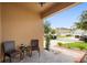 Cozy front porch features chairs and a small table, with a view of the well-kept neighborhood at 2254 Canyon Breeze Ave, Kissimmee, FL 34746