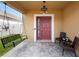 Inviting front porch with a swing, seating, and decorative tiled flooring at 2254 Canyon Breeze Ave, Kissimmee, FL 34746