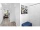 Hallway with neutral walls, wood-look flooring, and a cozy seating area near the stairs at 2254 Canyon Breeze Ave, Kissimmee, FL 34746