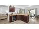 Kitchen features dark wood cabinets, granite countertops and a wine cooler near the breakfast nook at 2254 Canyon Breeze Ave, Kissimmee, FL 34746