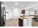 Open kitchen with dark wood cabinets, a breakfast bar, granite countertops and stainless appliances at 2254 Canyon Breeze Ave, Kissimmee, FL 34746