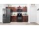 Modern kitchen featuring dark wood cabinets, granite countertops and stainless steel appliances at 2254 Canyon Breeze Ave, Kissimmee, FL 34746