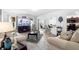 Bright living room showcases a fireplace, stylish furnishings, and a view into the dining area at 2254 Canyon Breeze Ave, Kissimmee, FL 34746