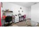Home office area featuring a desk, seating, shelving, and neutral carpeting at 2254 Canyon Breeze Ave, Kissimmee, FL 34746