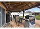 Covered outdoor kitchen area featuring a built-in grill and dining set, perfect for entertaining at 2254 Canyon Breeze Ave, Kissimmee, FL 34746