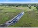Long dock and picturesque waterfront access amidst a lush, natural setting at 2921 Lake Tohopekaliga Blvd, Kissimmee, FL 34746