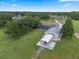 Aerial view shows outbuildings, in-ground pool, and expansive acreage at 2921 Lake Tohopekaliga Blvd, Kissimmee, FL 34746