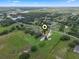 Aerial view shows property with spacious yard, detached garage, pool, and surroundings at 2921 Lake Tohopekaliga Blvd, Kissimmee, FL 34746