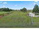 Aerial view of fenced land, showing the lake and a shed near the main residence at 2921 Lake Tohopekaliga Blvd, Kissimmee, FL 34746