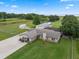 Expansive aerial view of property featuring a beautiful lawn and lake views at 2921 Lake Tohopekaliga Blvd, Kissimmee, FL 34746