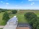 Aerial view features lake views, in-ground pool, and storage buildings on the property at 2921 Lake Tohopekaliga Blvd, Kissimmee, FL 34746