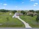 This property boasts a long driveway, lush lawn, multiple buildings, mature trees, and is fully fenced with lake views at 2921 Lake Tohopekaliga Blvd, Kissimmee, FL 34746