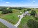Property featuring a long driveway, spacious lawn, multiple buildings, and mature trees, fully fenced with lake views at 2921 Lake Tohopekaliga Blvd, Kissimmee, FL 34746