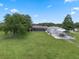 Expansive backyard featuring lush lawn, mature trees, pool, boat storage, and plenty of open space at 2921 Lake Tohopekaliga Blvd, Kissimmee, FL 34746