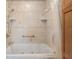 Well-lit bathroom with soaking tub and tiled surround, ready for relaxation at 2921 Lake Tohopekaliga Blvd, Kissimmee, FL 34746