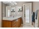 Bathroom with wood cabinets, decorative mirror, and a door to the exterior at 2921 Lake Tohopekaliga Blvd, Kissimmee, FL 34746