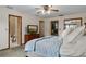 Cozy bedroom features a walk-in closet, bathroom access, and a dresser with a TV at 2921 Lake Tohopekaliga Blvd, Kissimmee, FL 34746