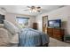 Bright bedroom with a view of the pool, a TV on the dresser, and an ensuite bathroom at 2921 Lake Tohopekaliga Blvd, Kissimmee, FL 34746