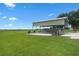 Spacious boat carport on a concrete pad with lawn extending to a field at 2921 Lake Tohopekaliga Blvd, Kissimmee, FL 34746