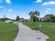 Property features an expansive driveway, lush lawn, and secure gated entrance at 2921 Lake Tohopekaliga Blvd, Kissimmee, FL 34746