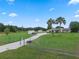 Expansive property featuring a single-story house, a brick-paved driveway, and lush lawns for outdoor enjoyment at 2921 Lake Tohopekaliga Blvd, Kissimmee, FL 34746