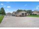 Property exterior featuring brick-paved driveway, fenced-in backyard, and additional garage space for storage at 2921 Lake Tohopekaliga Blvd, Kissimmee, FL 34746
