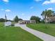 Sprawling property with a single-story house, brick-paved driveway, lush lawn, and a trailer for convenience at 2921 Lake Tohopekaliga Blvd, Kissimmee, FL 34746