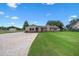Inviting single-story home boasts a lush front lawn, brick-paved driveway, and well-maintained landscaping at 2921 Lake Tohopekaliga Blvd, Kissimmee, FL 34746