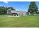 Property features large detached garage, covered parking, and grassy lawn at 2921 Lake Tohopekaliga Blvd, Kissimmee, FL 34746